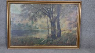 A gilt framed oil on canvas, trees by a lake, signed H. Delfs Kiel. H.80 W.120cm