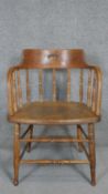 A 19th century oak framed captain's chair with elm seat.