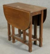 A mid century oak drop leaf table. H.73 W.34 D.76cm