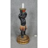 A carved painted and gilded wooden blackamoor table lamp. H.60cm