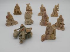 Ten carved Chinese soapstone figures of immortals.