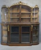 A mid Victorian rosewood and giltwood credenza, circa 1850, the upper section with a shell and