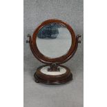 A 19th century mahogany Empire style swing toilet mirror on circular marble base. H.60 W.50cm