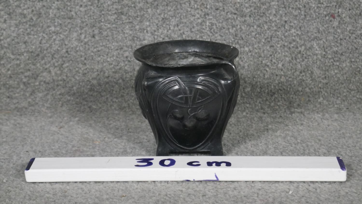 An Art Nouveau twin handled patinated pewter vase with stylised foliate and cherry design, on four - Image 2 of 3