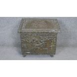 A vintage brass embossed log box with figural decoration. H.47 W.50 D.33cm