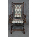 An American painted frame child's rocking chair in Arts and Crafts style upholstery. H.74 W.40cm