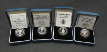 Four Royal Mint cased silver proof pound coins. Each in pale blue presentation case with COA.