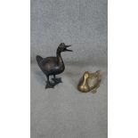 Two bronze effect brass duck sculptures, intricately detailed.