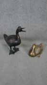 Two bronze effect brass duck sculptures, intricately detailed.