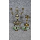 A brass and porcelain twin branch candelabra, a pair of brass chambersticks and a Gothic brass