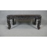 A carved Burmese hardwood coffee table on cabriole supports. H.44 W.90 D.46cm