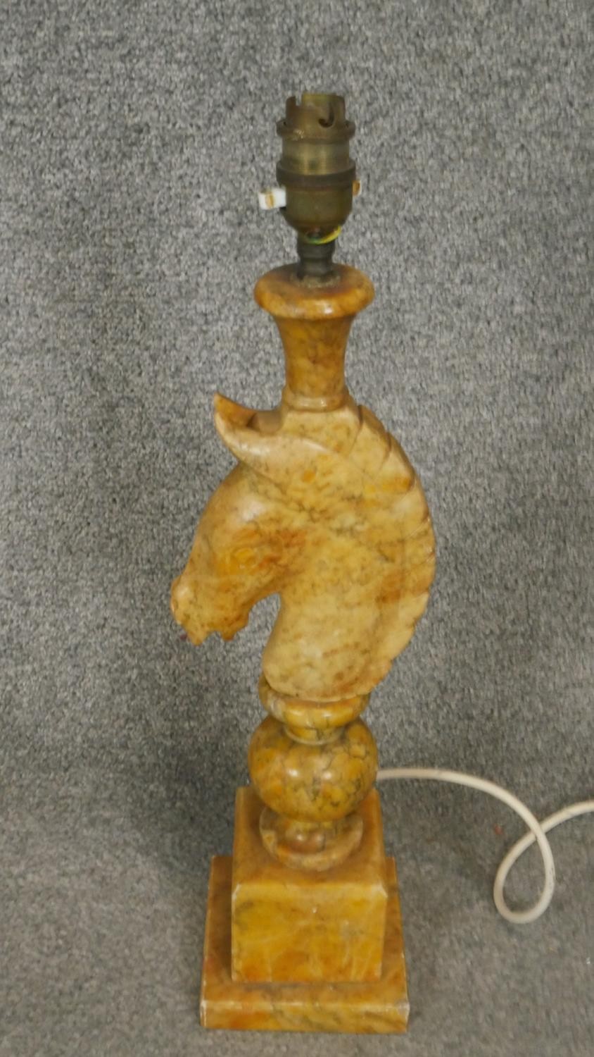 A vintage carved alabaster table lamp in the form of a horses head on stepped base. H.49cm