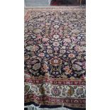 A Indo Heriz carpet with foliate design across the field on a midnight ground. 410x310cm