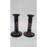 A pair of Moorcroft Anemone pattern (Blue) tall candlesticks. With impressed date cypher (1993)