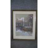 A framed and glazed watercolour Dutch barges in a port town, indistinctly signed and dated. H.60 W.
