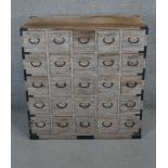 A Chinese elm and metal bound spice chest fitted with twenty five drawers. H.103 W.97 D.40cm