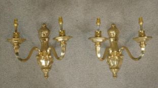 A pair of Dutch style brass twin branch wall sconces.