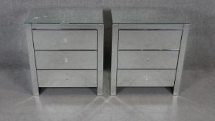 A pair of mirrored three drawer bedside chests. H.70 W.63 D.40cm (one damaged as photographed).