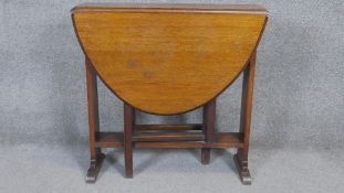 A mid century oak drop flap Sutherland table with gateleg action. H.74 W.74 D.25cm