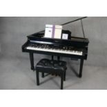 A Roland KR 115 digital intelligent grand piano finished in black lacquered case along with matching