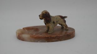 A vintage marble ashtray with a cold painted figure of a spaniel.