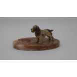 A vintage marble ashtray with a cold painted figure of a spaniel.