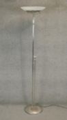 A contemporary metal uplighter with frosted shade. H.182cm