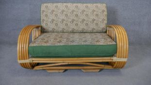 A vintage Continental bamboo sofa in its original floral upholstery. H.80 W.123 D.100cm