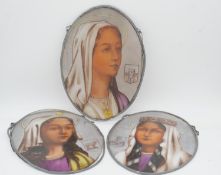 Three oval religious painted glass panels of female figures. H.42 W.30cm