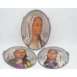 Three oval religious painted glass panels of female figures. H.42 W.30cm