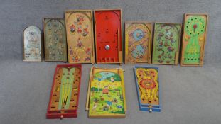 A collection of vintage painted wooden childrens tabletop games. Including various pinball and