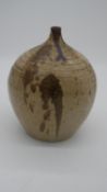 A large onion shaped Studio Pottery stoneware vase with cream glaze and abstract brown speckling.