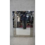 A contemporary wall mirror in glazed frame. H.103 W.76cm