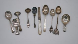 A collection of ten pieces of silver cutlery. Including spoons and a mother of pearl handled