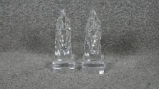 A pair of glass horse head book ends. W.4 H.12 D.8