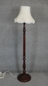 A mahogany standard lamp with turned column on platform base. H.168cm