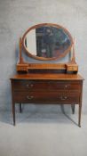 An Edwardian 'Sheraton Revival' mahogany dressing table, mirrored back with two small drawers, the