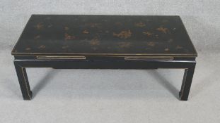 A lacquered Chinese coffee table with hand gilded decoration. H.40 W.118 D.59