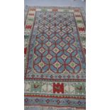 A Turkish Kars carpet with repeating geometric motif across the field within stylised multiple