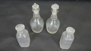 Two pairs of cut crystal decanters. Including a pair of Georgian blown glass three ring decanters
