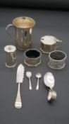 A collection of antique silver. Including a hammered silver tankard, two silver napkin rings, a