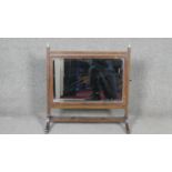 A 19th century mahogany and satinwood strung skeleton framed toilet mirror. W.64 D.28 H.60