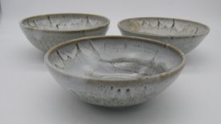 Three large studio pottery white and brown glazed bowls. Indistinct makers stamp. H.9 W.24cm (