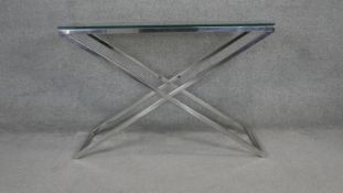 An Andrew Martin style glass topped console table on X frame chromium base. H.76 W.112 D.36cm