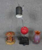 A collection of curiosities. Including a floating apple vintage desk light, a Loetz style orange Art