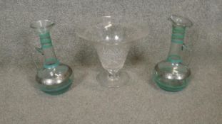 A collection of glass ware. Including a pair of silvered blown glass carafes and a cut crystal vase.