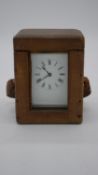 A 19th century leather cased French brass carriage clock with glass plates. H.13 W.10 D.9cm