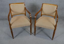 A pair of contemporary late Georgian style armchairs on reeded tapering supports.