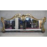 A large and decorative 19th century painted and carved overmantel mirror. H.95 W.216cm (From a