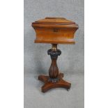 A William IV rosewood work table with sarcophagus form fitted top above reeded baluster form